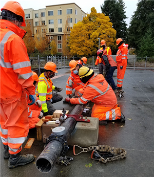 Apprentices training on water pipe construction.