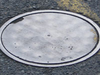 worn metal cover in roadway