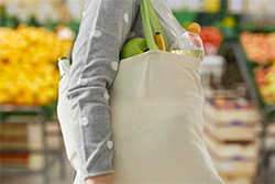 Woman carrying groceries in cloth bag