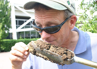 Image of man smelling soil