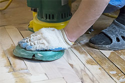 Person sanding reusable floor