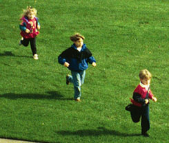 Photo of children running on grass