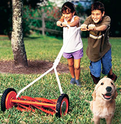 Photo of 2 children pushing mower