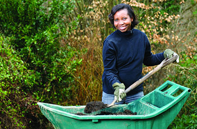 Photo of woman shoveling compost