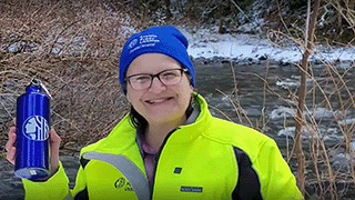 Photo of Amy LaBarge in front of the Cedar River in winter.