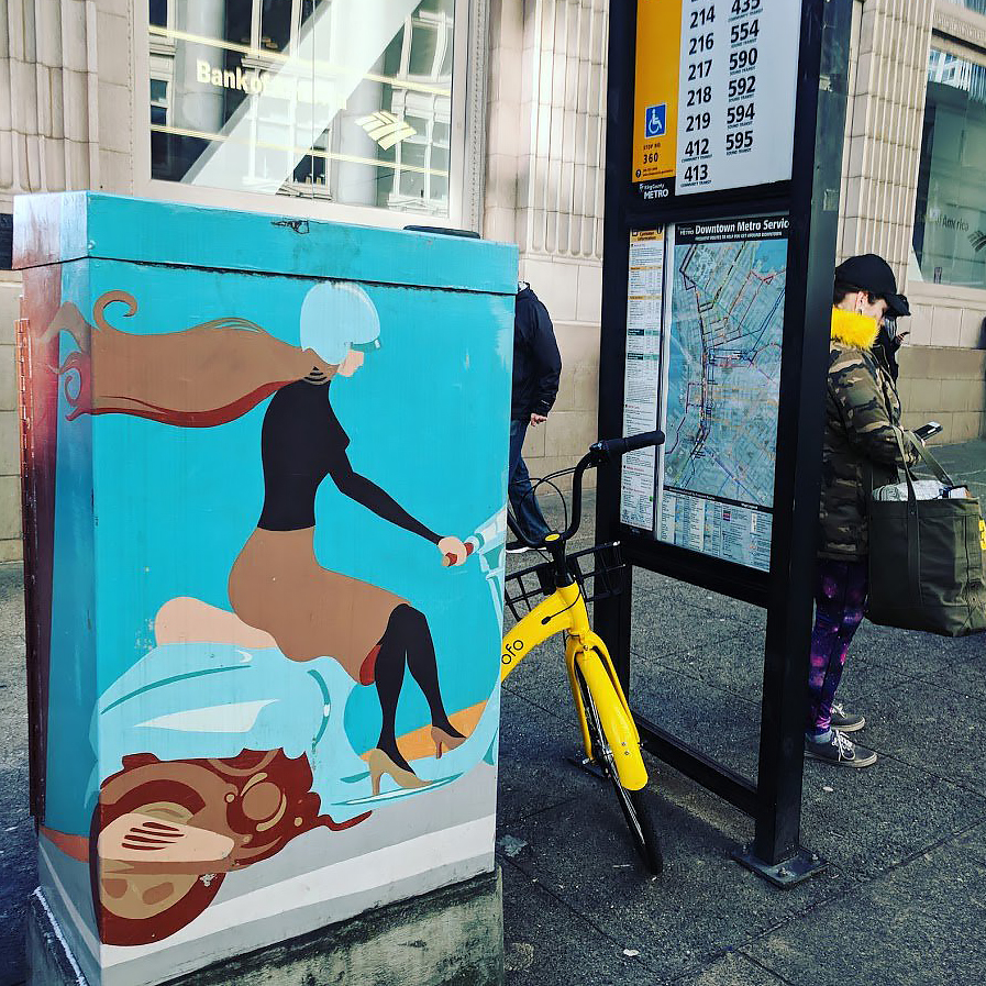 Public Art on Utility Cabinet Blends with Bike Share Bike at Transit Stop Public Art on Utility Cabinet Blends with Bike Share Bike at Transit Stop