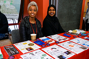 Two young women tabling at an immigration event.