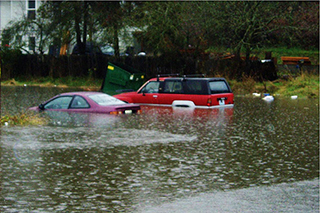 Image of two vehicles in flood waters in Seattle's South Park neighborhood