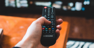Hand holding a TV remote