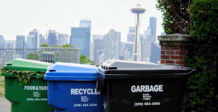 Garbage, recycling, and compost bins with the Space Needle in the background
