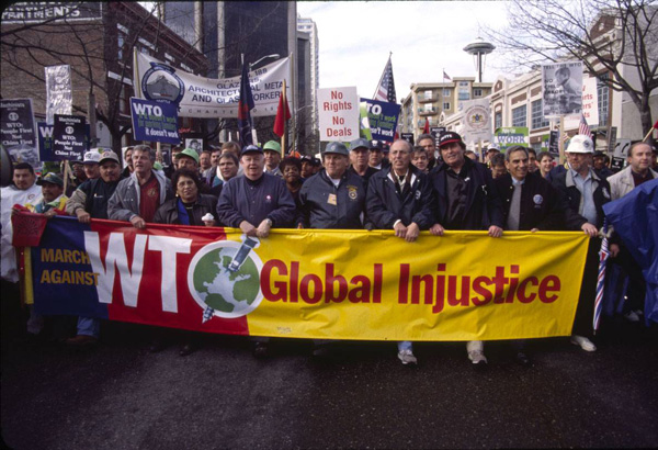Citation: Labor protestors with banner, November 30, 1999. Copyright Peter Yates.