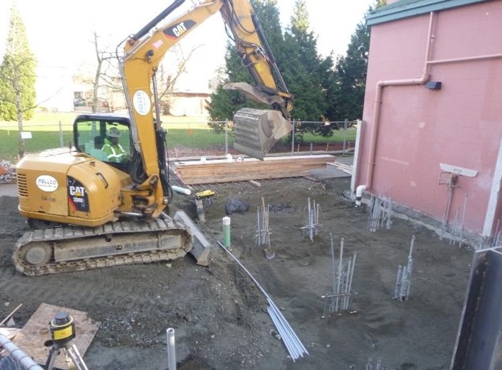 Crews use an excavator at Miller Community Center