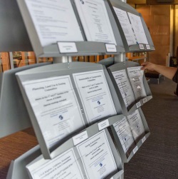 City Council meeting agendas and notices on a stand outside Council Chamber doors