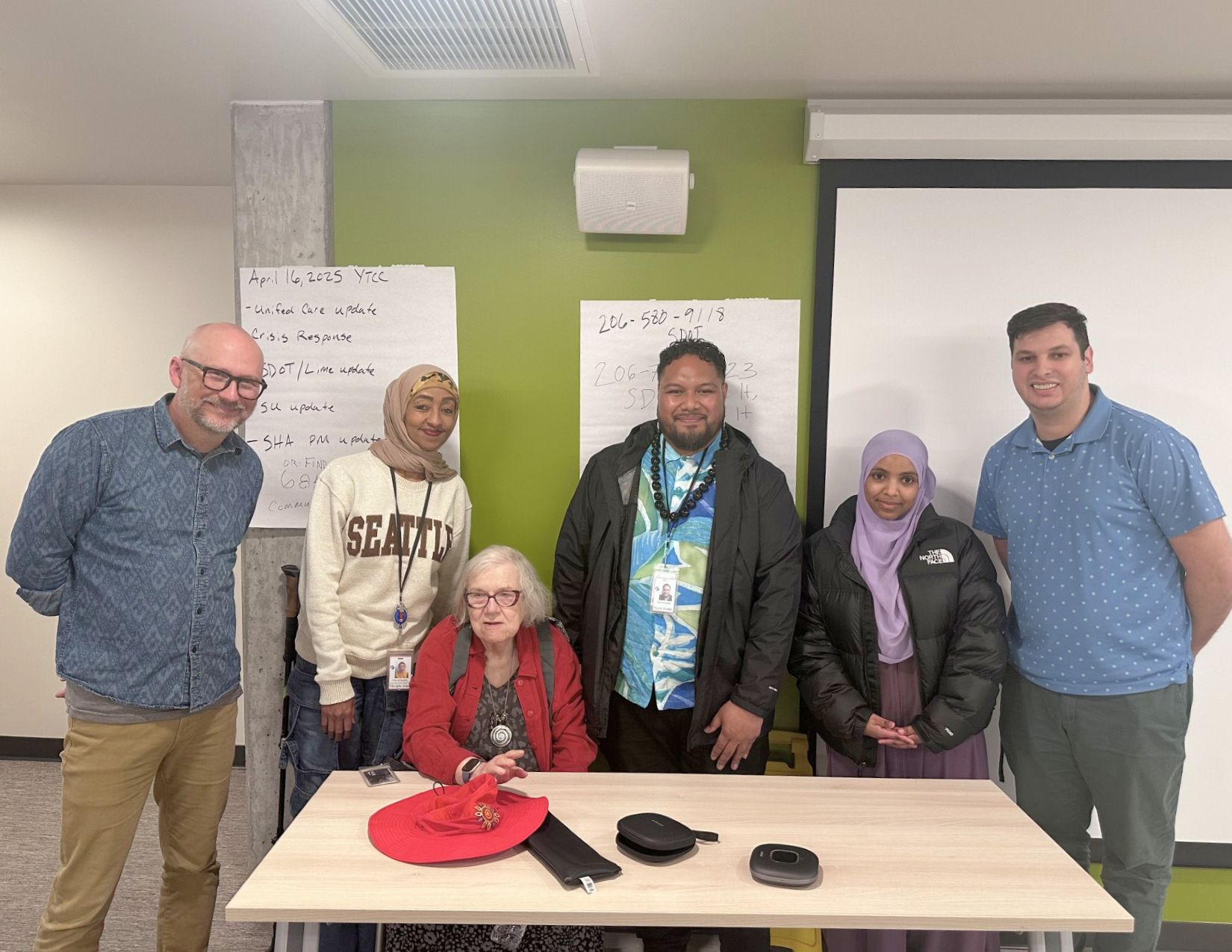 CPC staff members Mergitu Argo, Mario Teulilo, and Kieryn High with members of Yesler Terrace Community Council.