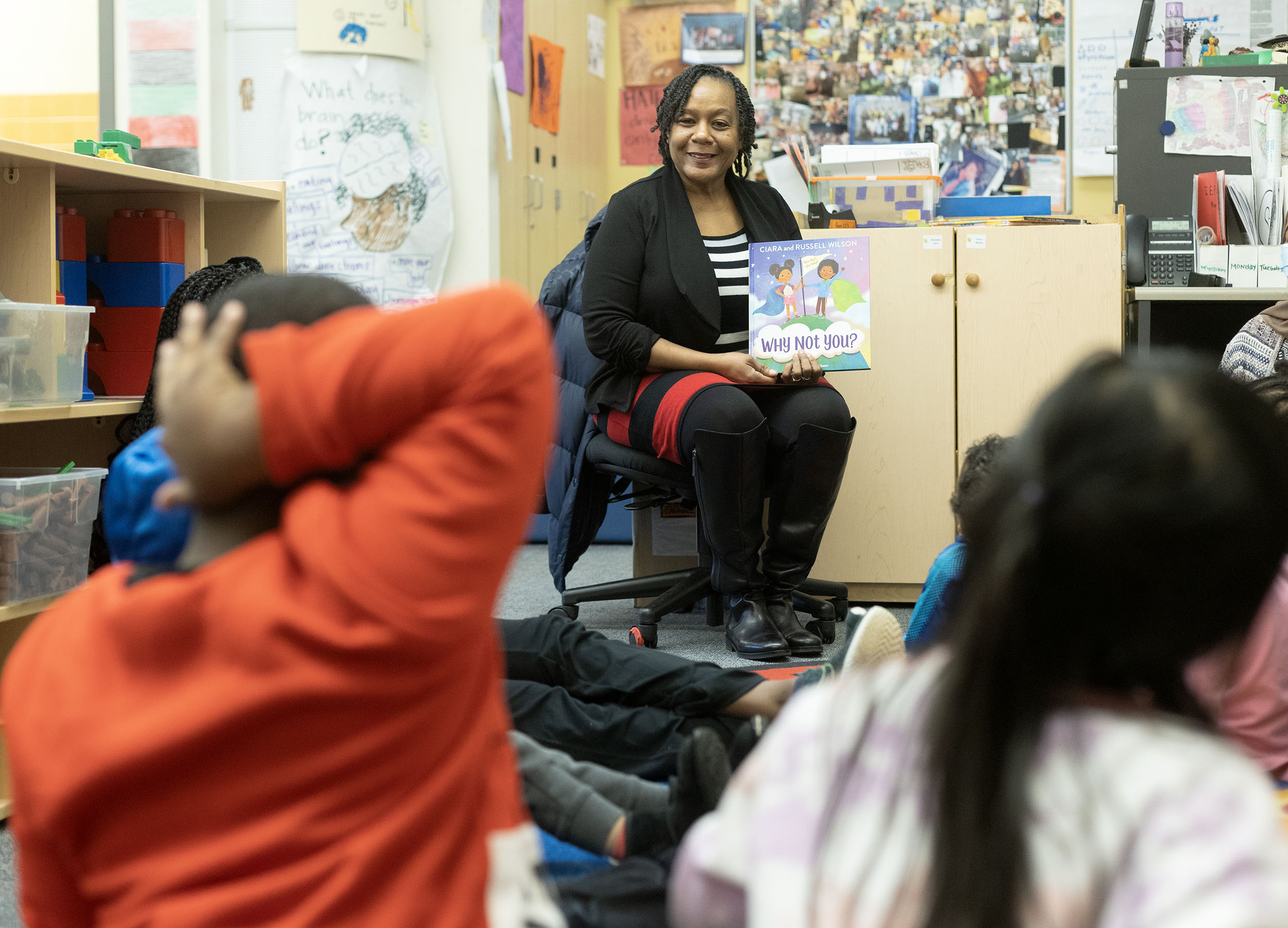 Photo of Felicia Cross reading to school children