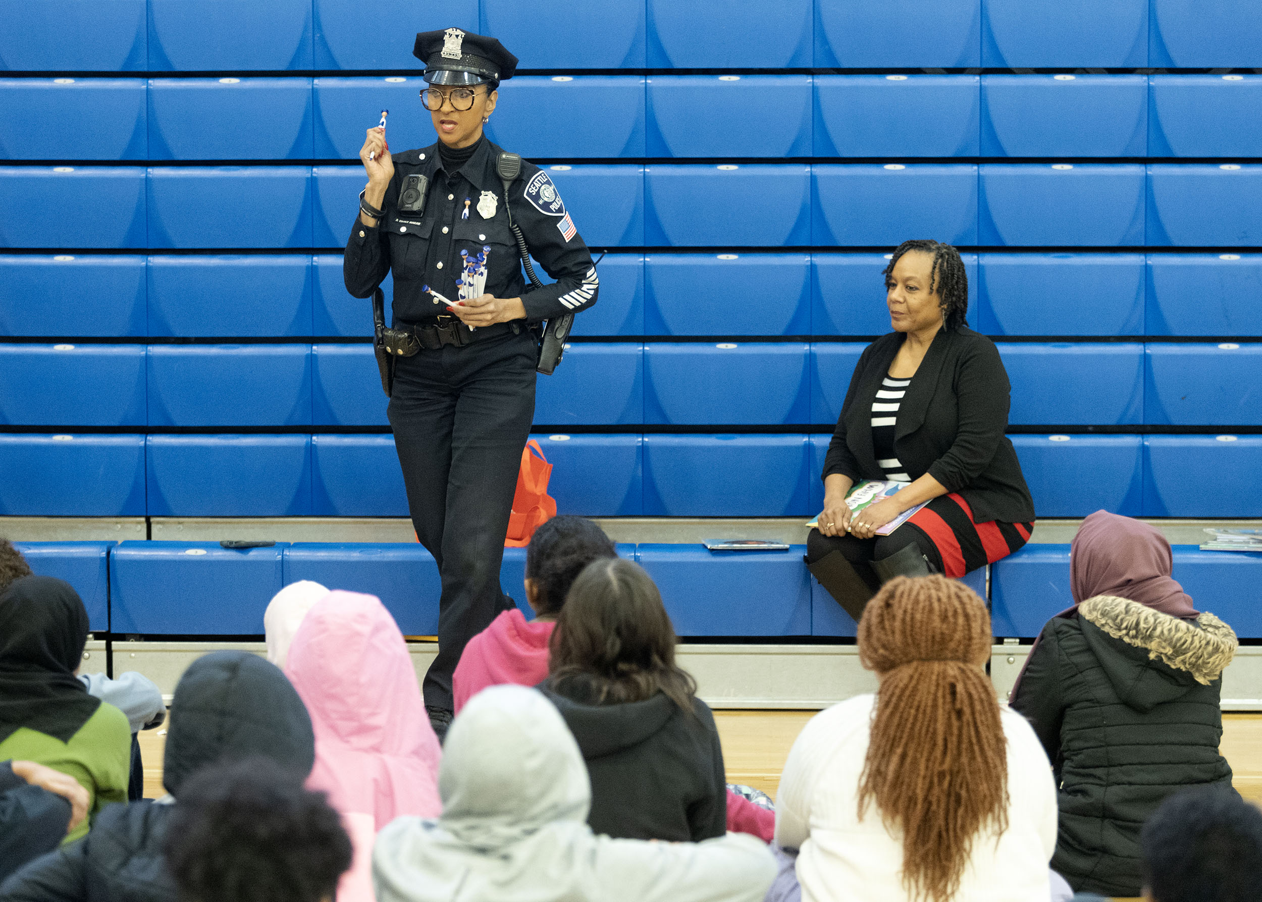 Photo of SPD Detective Cookie and Felicia Cross in front of a group of children