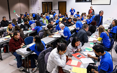 Community members in classroom for programming held by Office of Immigration and Refugees