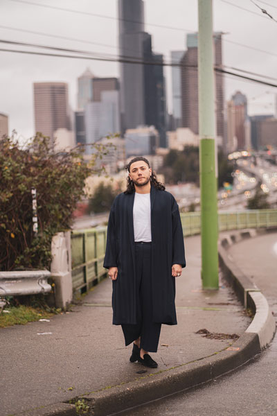 Dujie stands on the Jose Rizal Bridge with the downtown skyline behind.