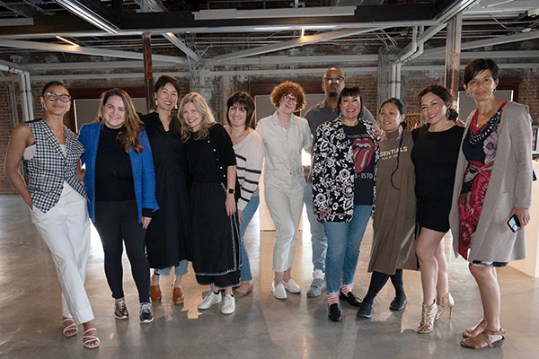 11 members of Seattle Arts Commission pose inside the ARTS at King Street Station gallery