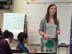 Woman presenting an educational program to students