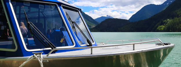 A view of Diablo Lake over the front of a tour boat