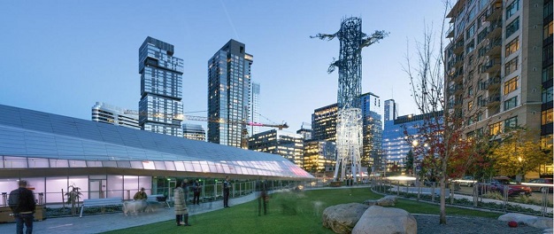 A view of the Denny substation and surrounding high rise buildings with a tree sculpture in the center