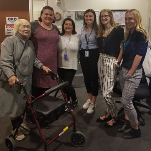 A group of six women smiling