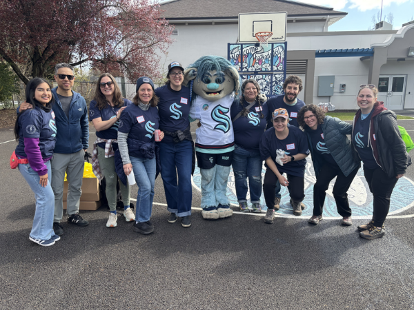 Staff from the Mayor&rsquo;s Office and Office of Sustainability & Environment with Buoy, the Seattle Kraken mascot.