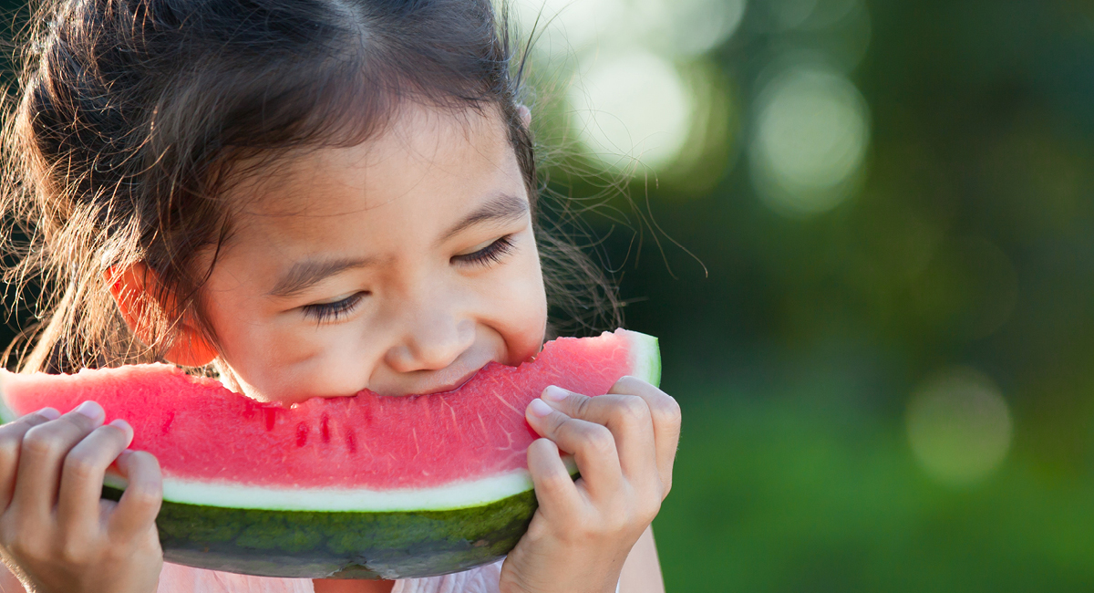 Young girl eating watermelon