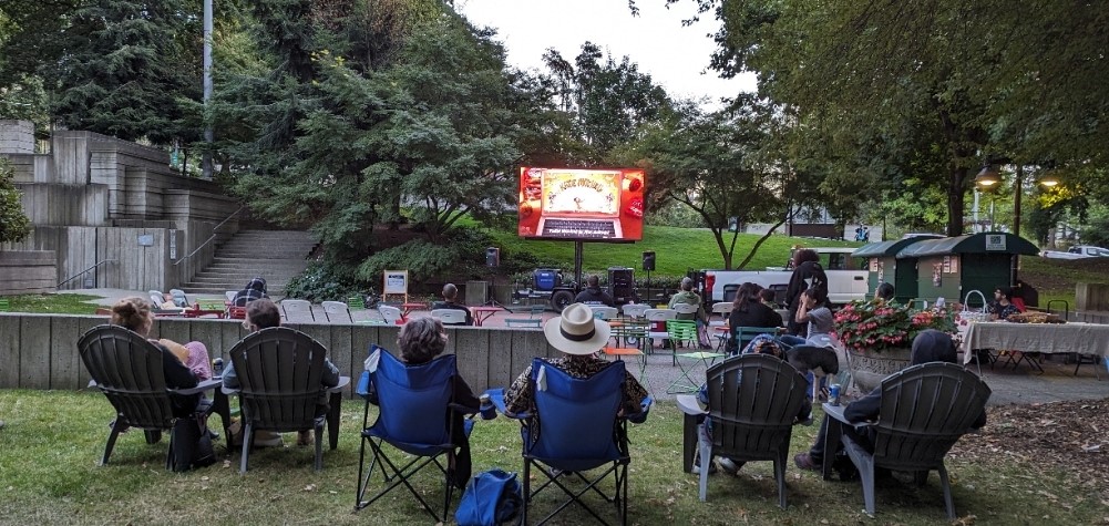 Park Goers enjoying a movie on the outdoor movie screen at Freeway Park