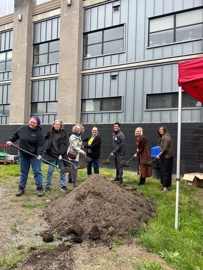 Group of people with shovels and dirt at a groundbreaking