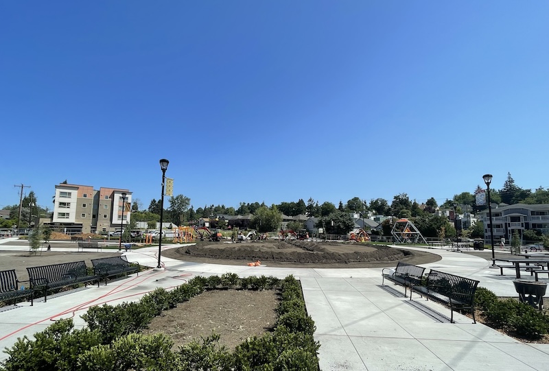 North Rainier site in progress - dirt plies in a circle, with a paved pavilion and seating benches around the perimeter