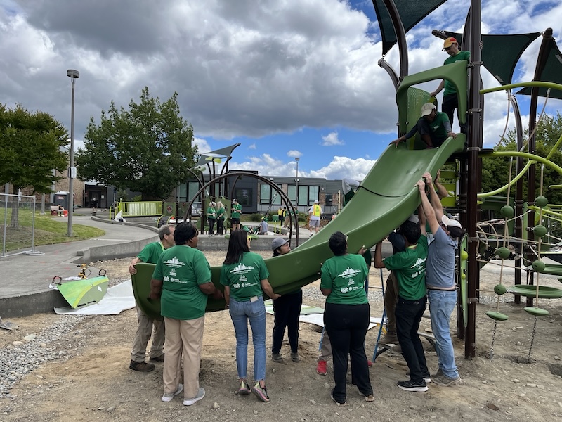 Volunteers from Greater Greener Conference building the play area at TT minor park