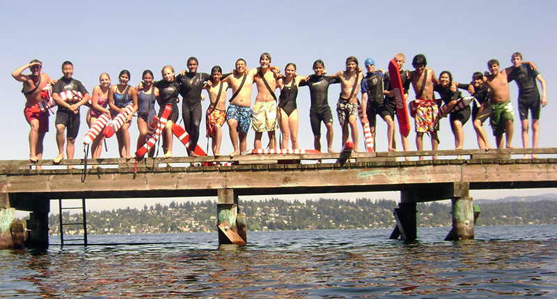 Lifeguards in training, lined up on a pier