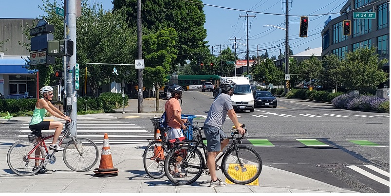 Cyclists waiting to cross Stone Way N