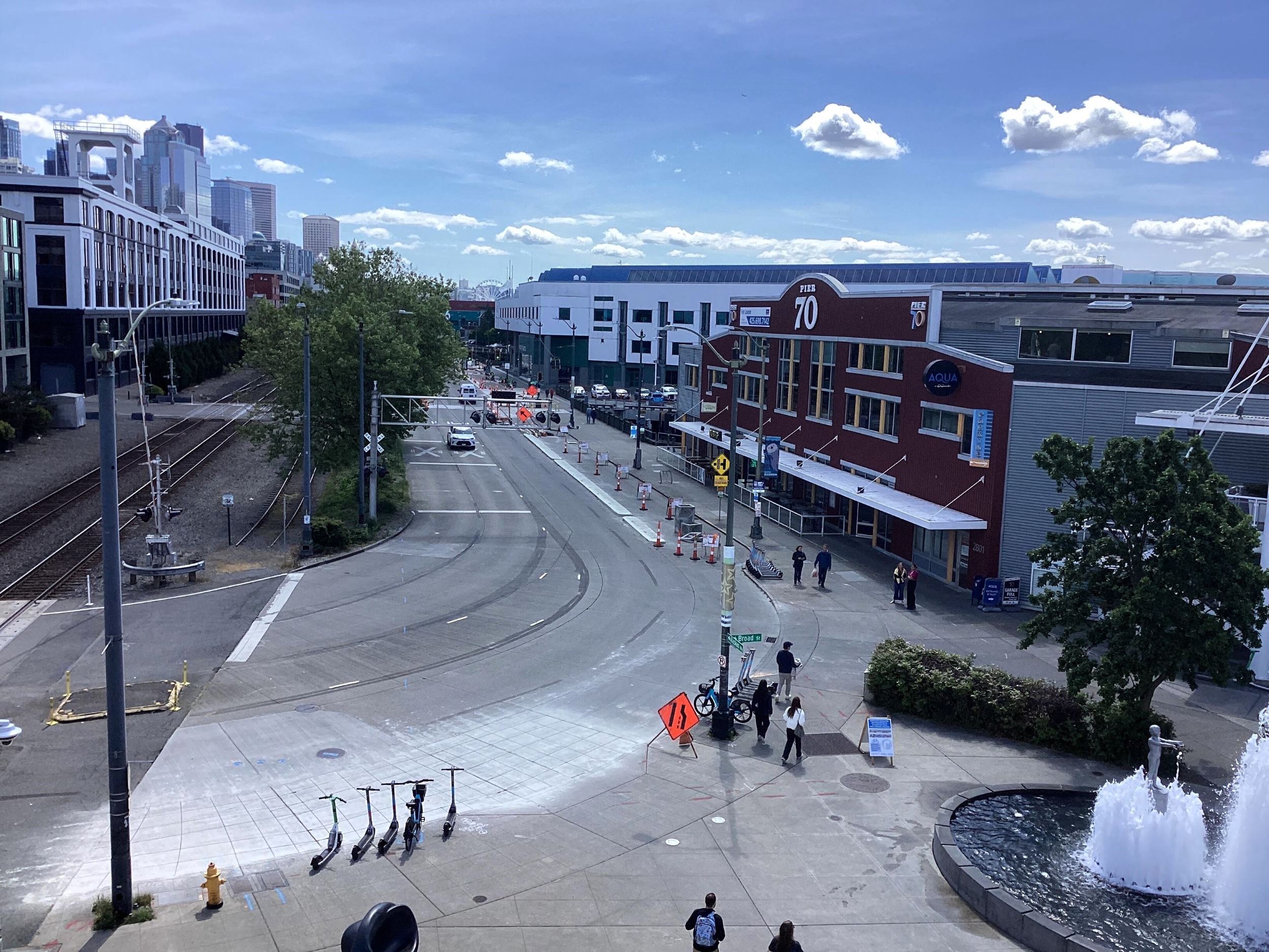 View of Alaskan Way looking south from Broad St showing newly installed concrete buffers for protected bike lane.