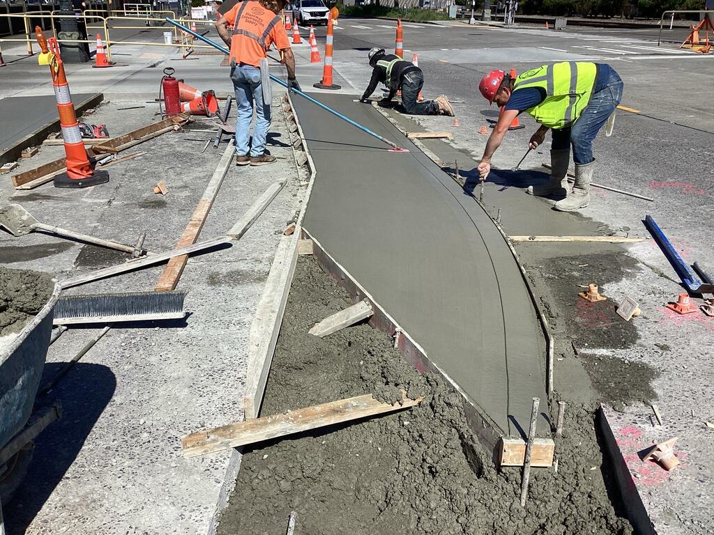 Photo showing crews paving the driveway at Pier 69.
