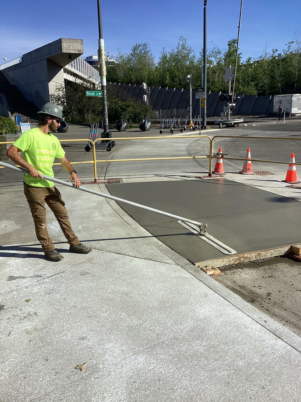 Crews finishing a section of concrete driveway at Broad St.