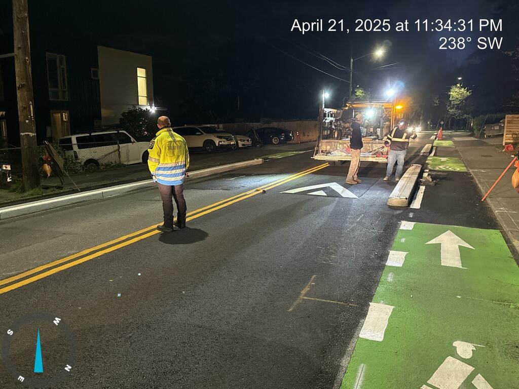 Crews striping the roadway on 15th Ave S