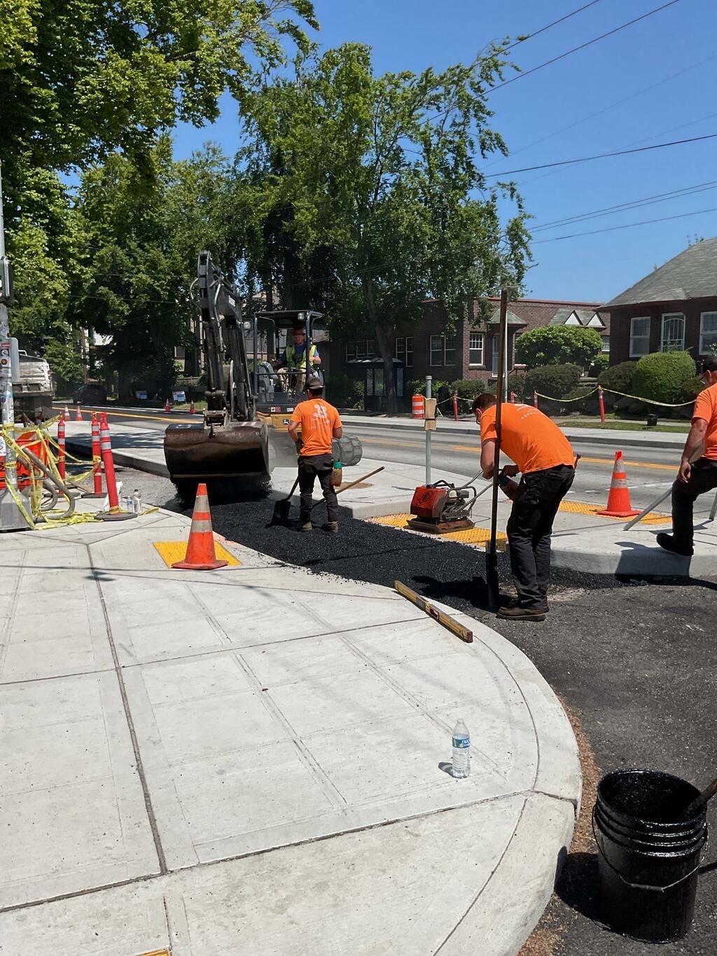 Crews paving the bike lane near S Hanford St
