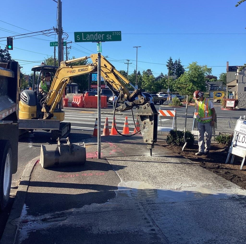 Crews removing sidewalk on Beacon Ave S near S Lander St.