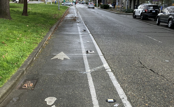 A close up of a bike lane with flexposts missing