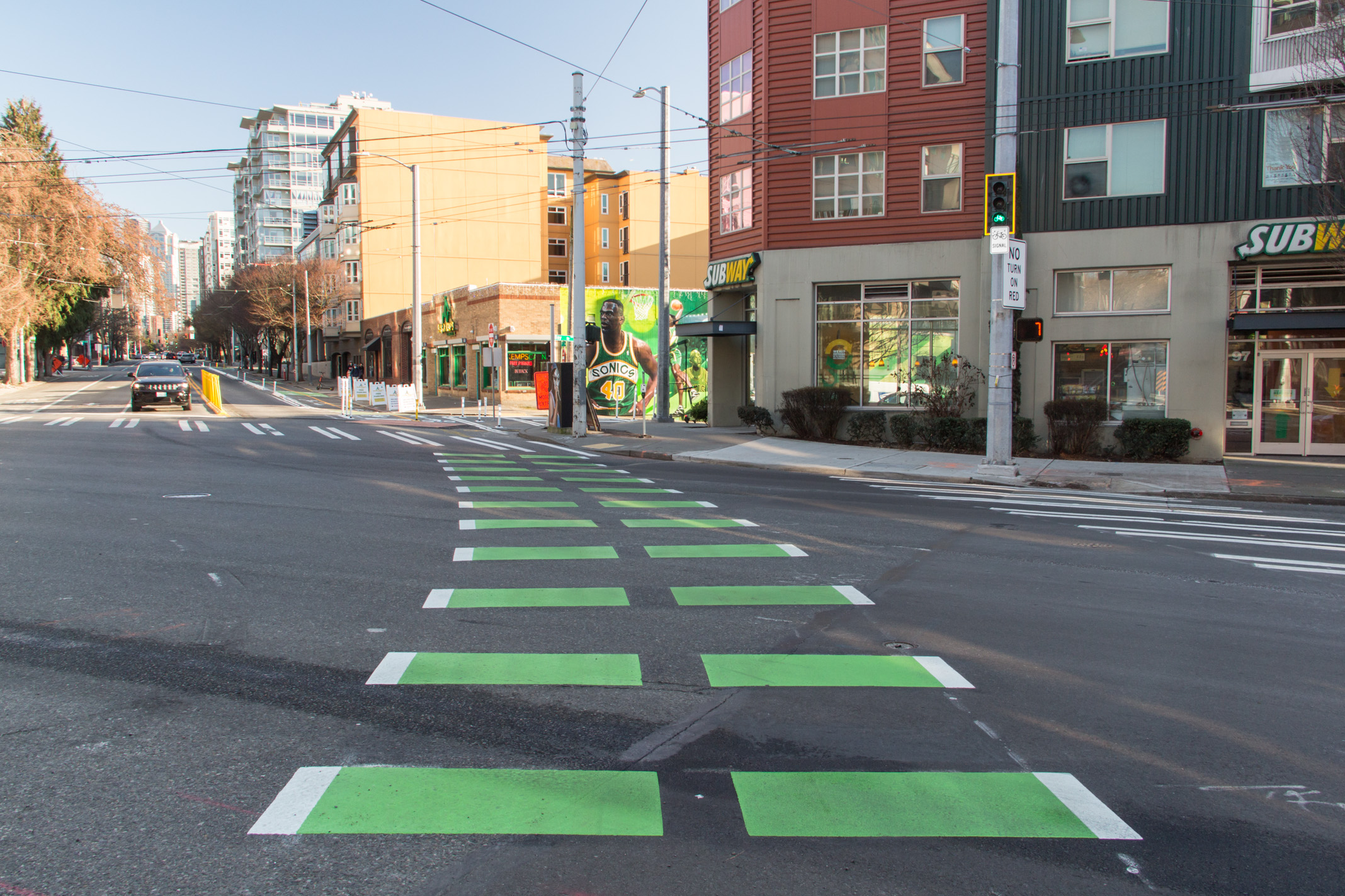 Image showing bike crossing across Denny Way on the west side of 1st Ave, connecting to the new two-way protected bike lanes on 1st Ave.