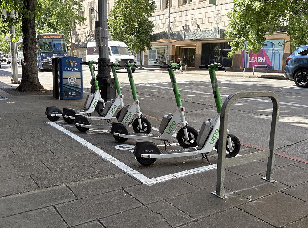 Example of a bike and scooter parking zone - on the sidewalk there is a large box with an icon of a bike and scooter inside.