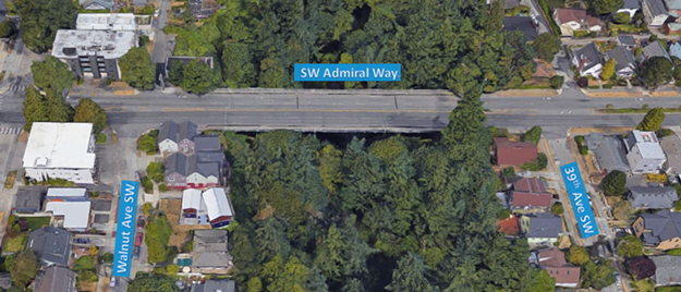 Aerial view of the SW Admiral Way Bridge, surrounded by dense greenery and residential neighborhoods. The image labels key streets, including Walnut Ave SW and 39th Ave SW, which intersect near the bridge.