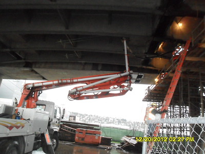 Concrete is poured into a form on the underside of the Ballard Bridge in 2013. The addition of concrete is part of the seismic retrofit project to strengthen the bridge.