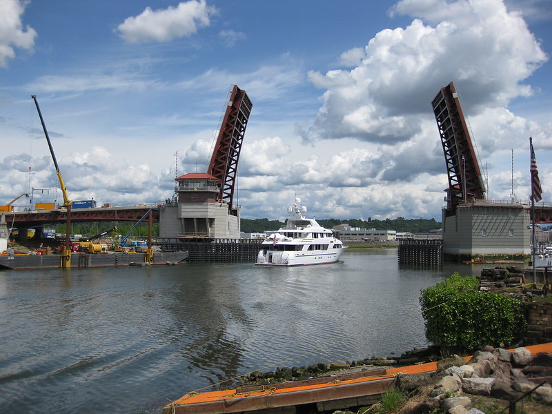 A yacht sails under the open South Park Bridge