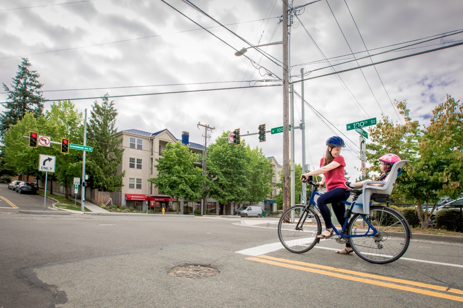 A woman and child on a bike at a new signalized crossing