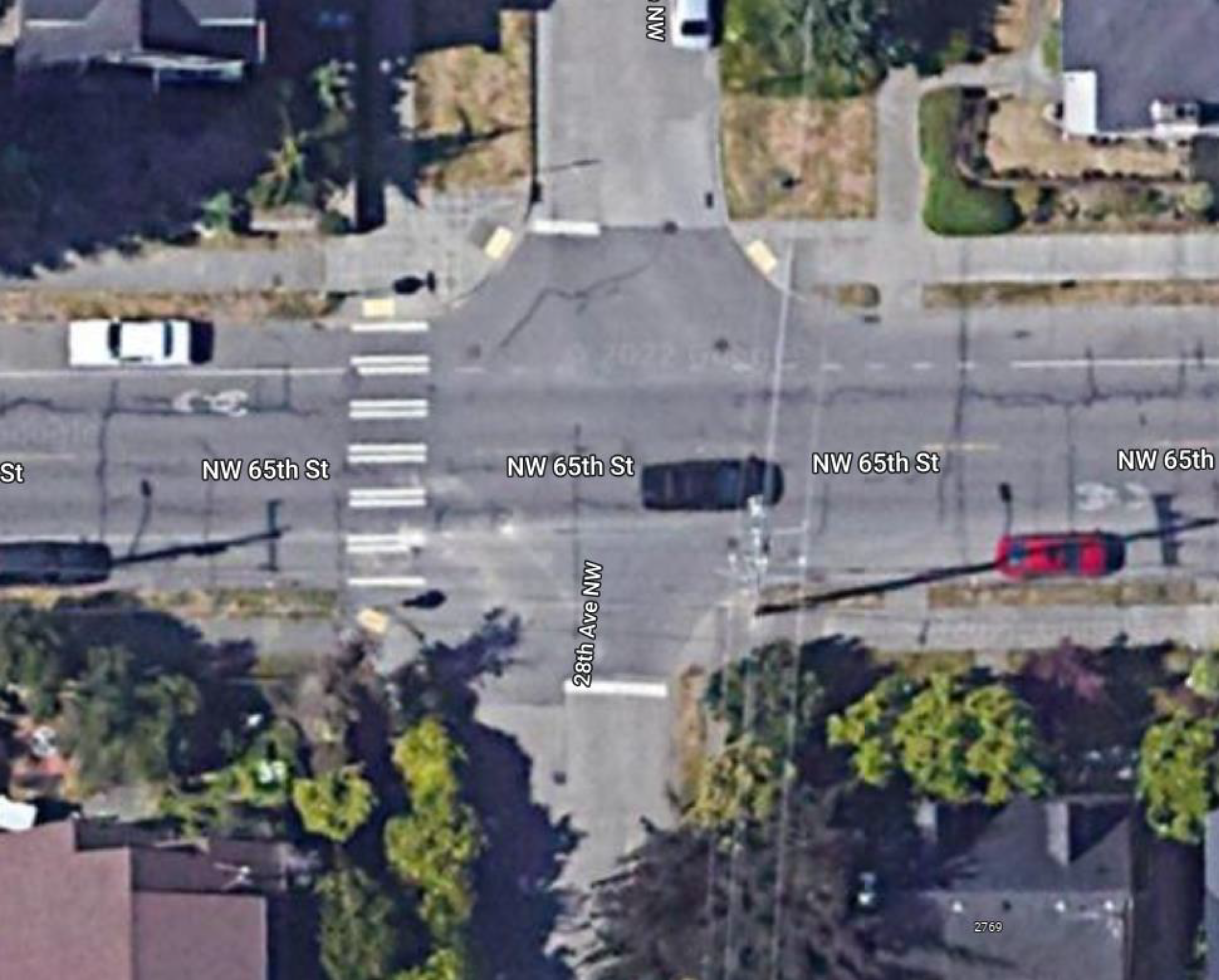 Satellite image of NW 65th St & 28th Ave NW intersection showing where new pavement markings will go