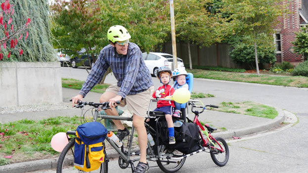 Father and two small children on an electric cargo bike
